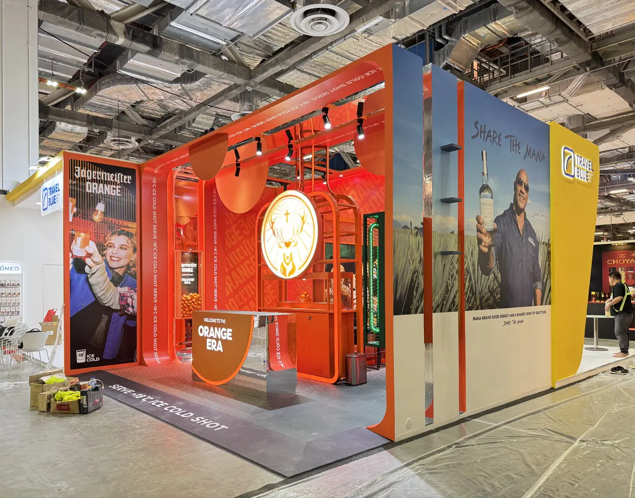 Saturated orange Jägermeister activation with an illuminated deer mark and experiential counter