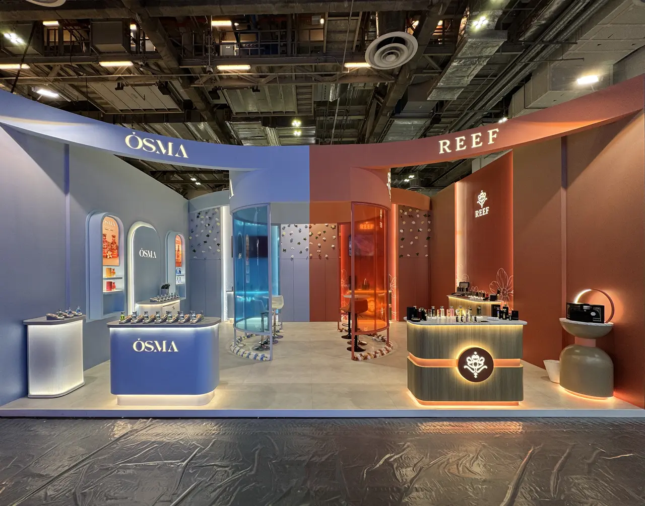 Blue and terracotta REEF and OSMA beauty exhibition environment with illuminated product displays