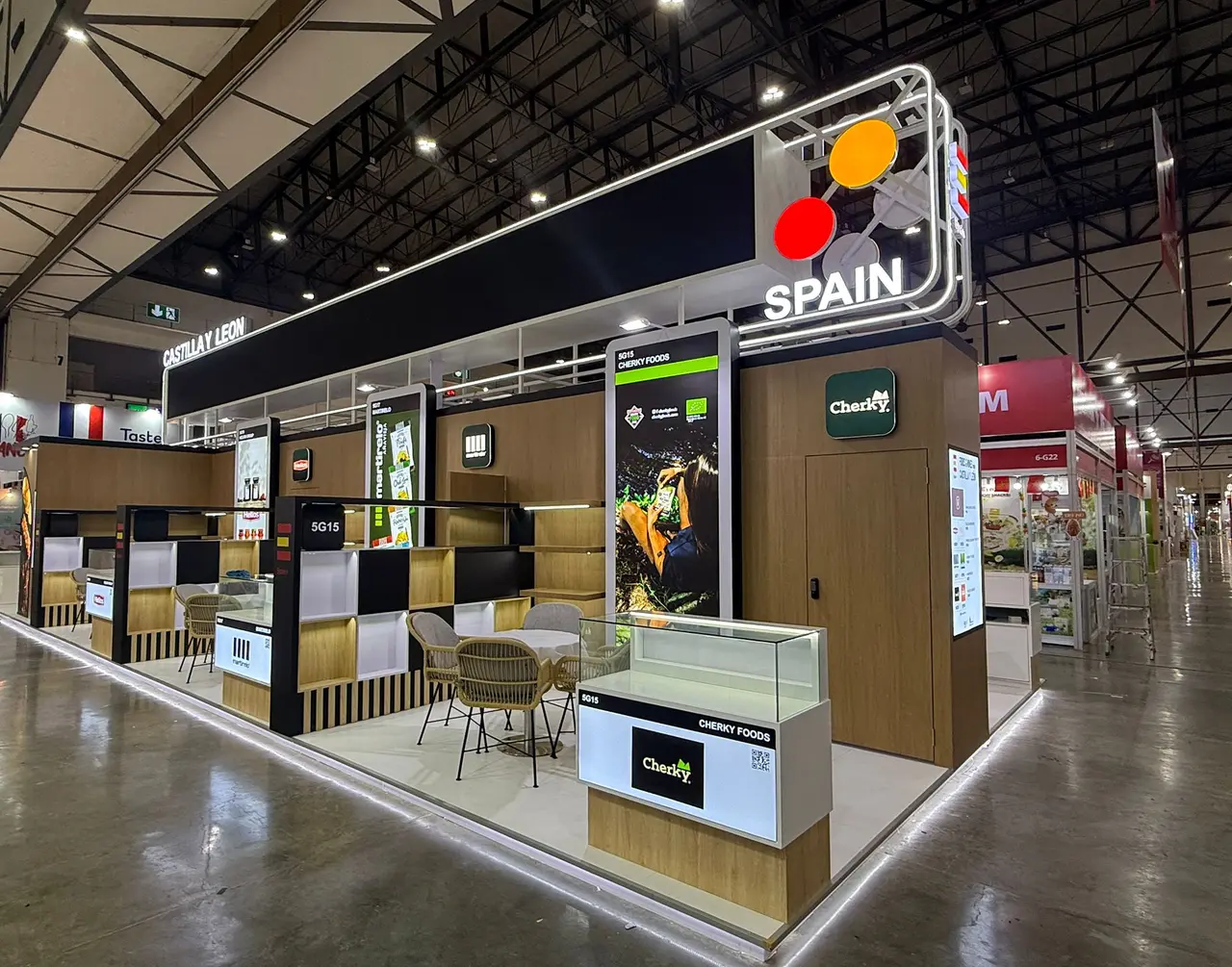Spain pavilion with illuminated country branding, timber product bays and display counters for multiple food brands