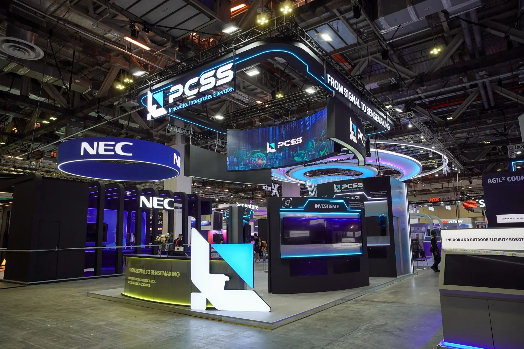 Completed PCSS custom exhibition stand with integrated lighting and digital displays